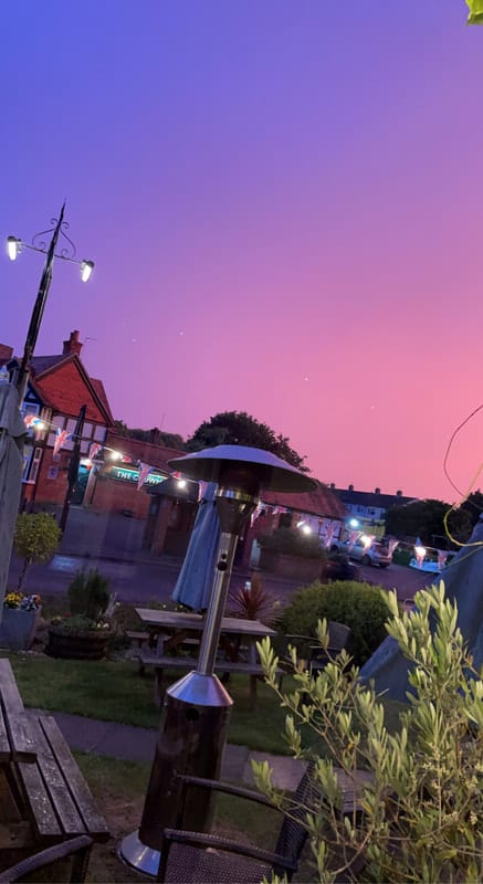 The pub at dusk, under a pink evening sky